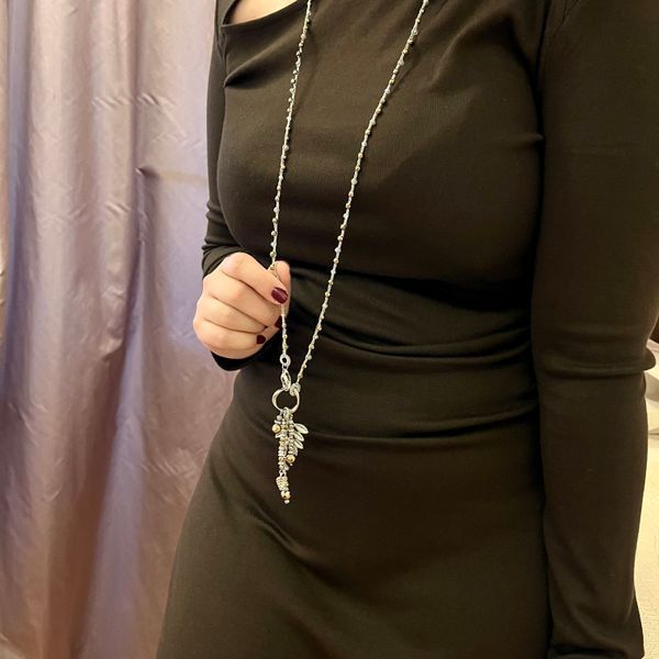 Long beaded necklace with grey faceted beads and dark gold beads
